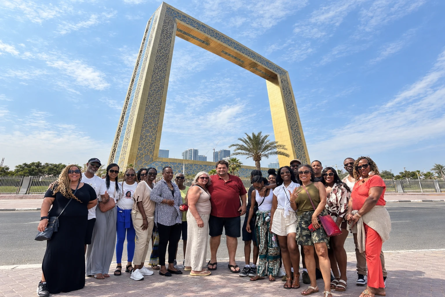 Group of travelers posing at Dubai Frame during a Dubai city tour
