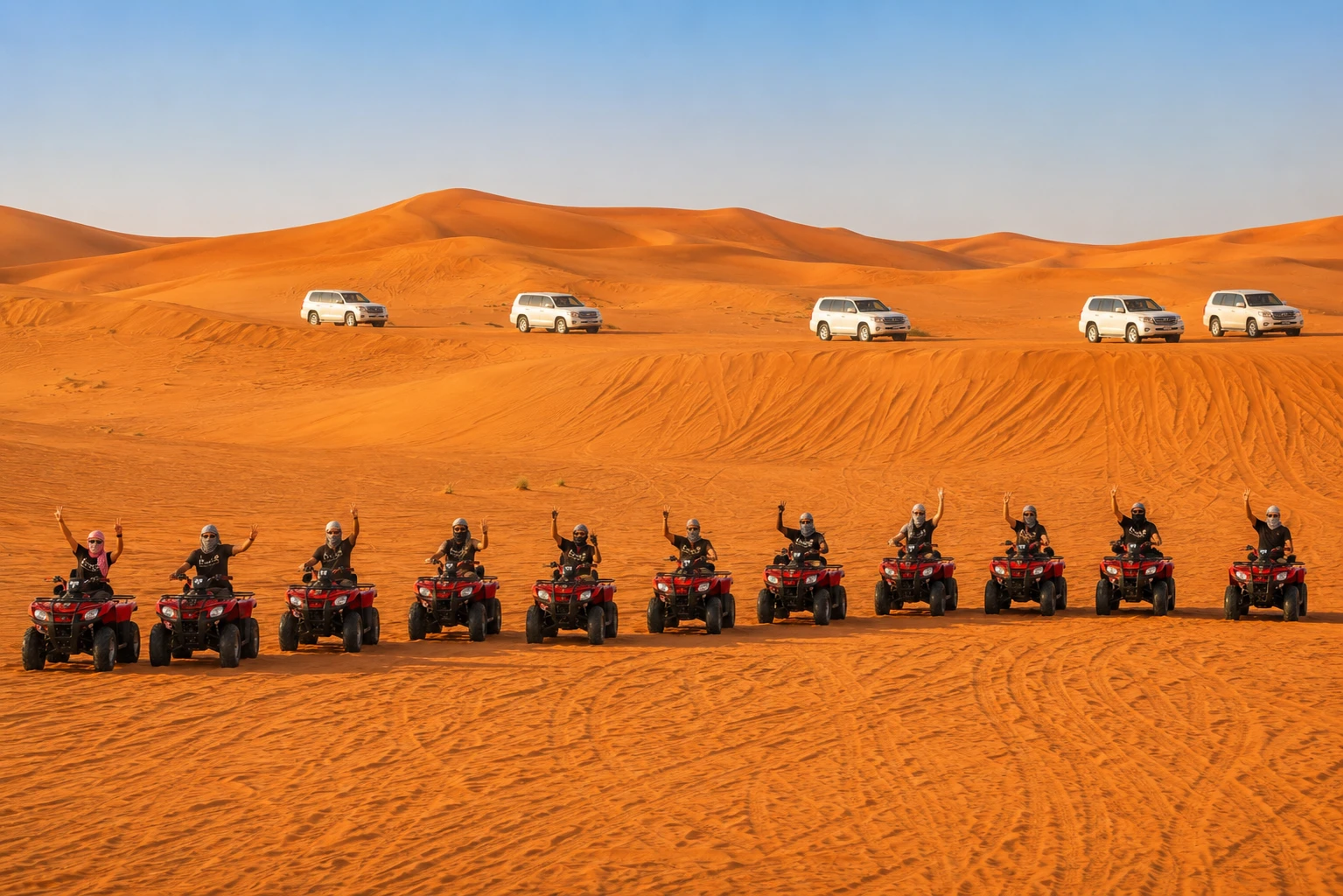 Group of travelers enjoying quadbike ride duringMorning Desert Safari Tour